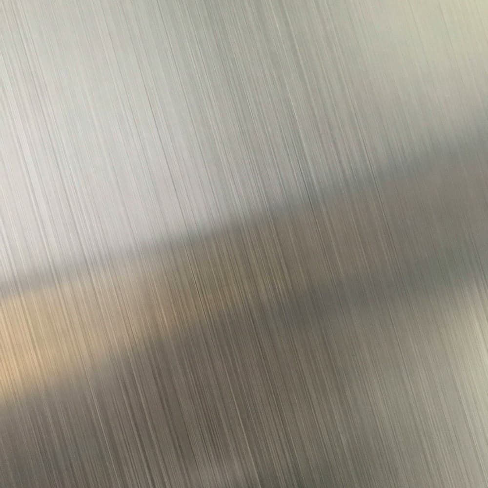 Brushed steel surface catching soft light