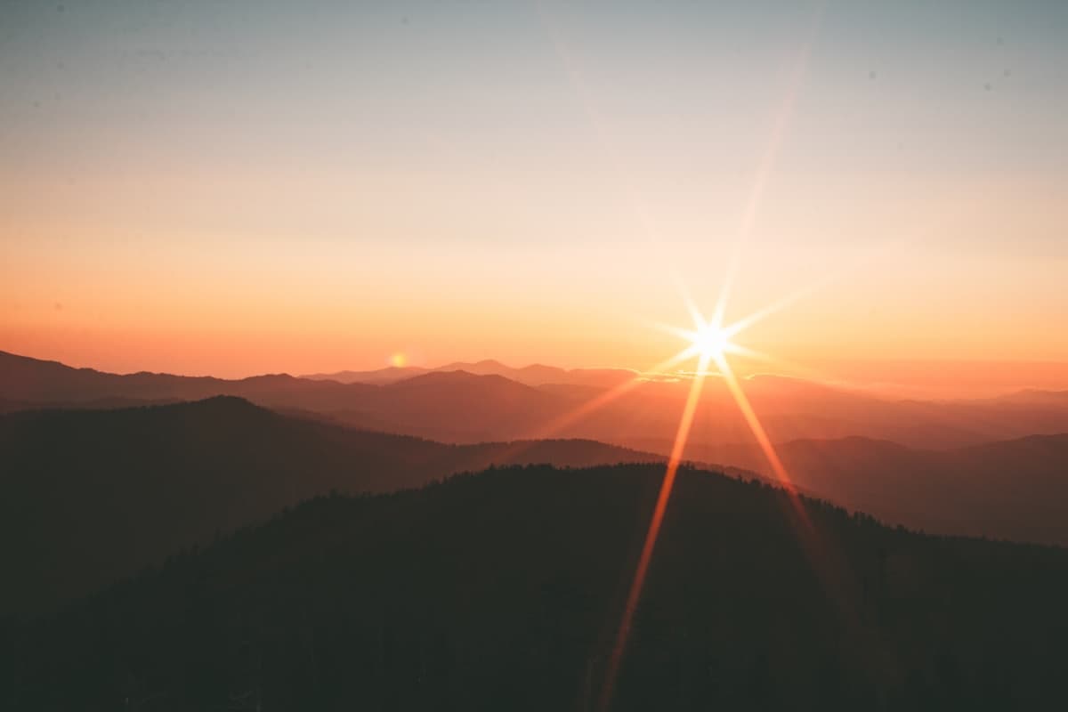 A soft sunrise over calm hills